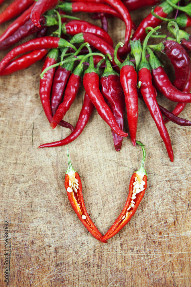Red hot chili peppers on old wooden table Red hot chili peppers on old wooden table