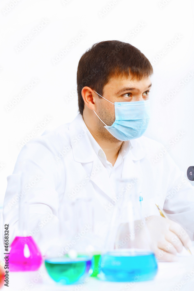 Young male scientist working in laboratory Young male scientist working in laboratory