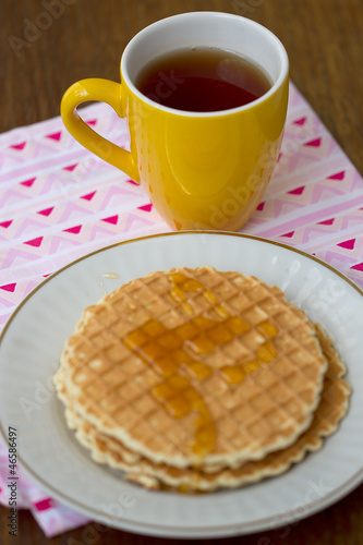 Round wafers, yellow cup of tea