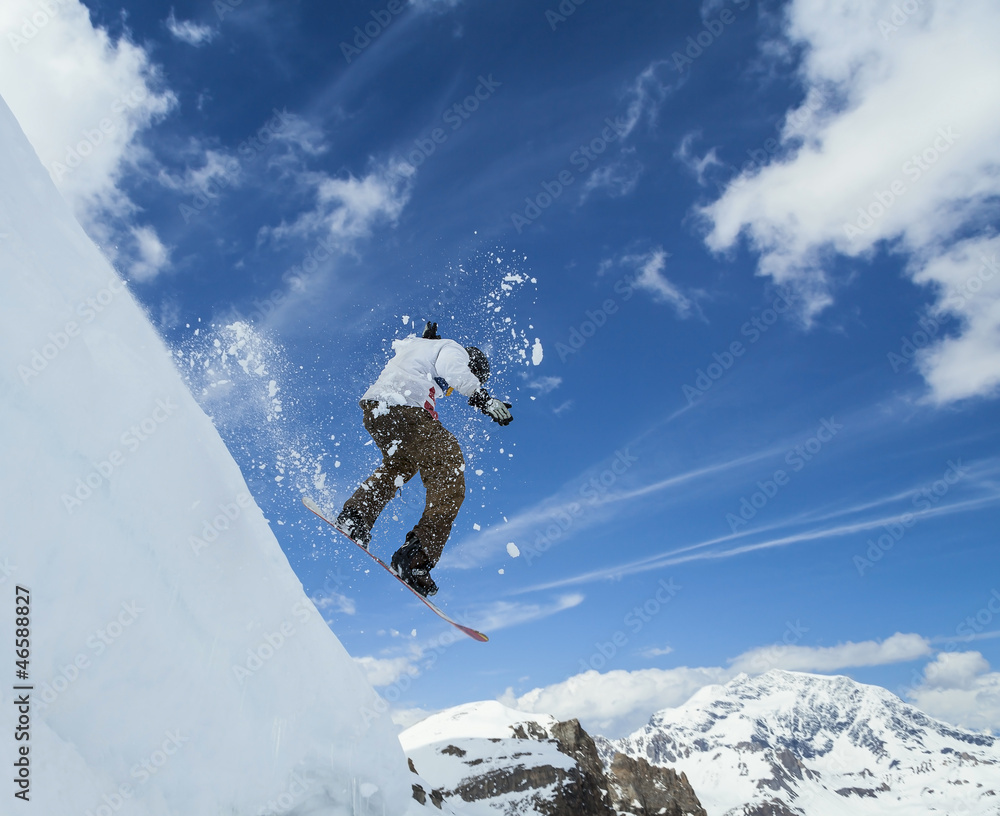 Snowboarder jumping in mountains Snowboarder jumping in mountains
