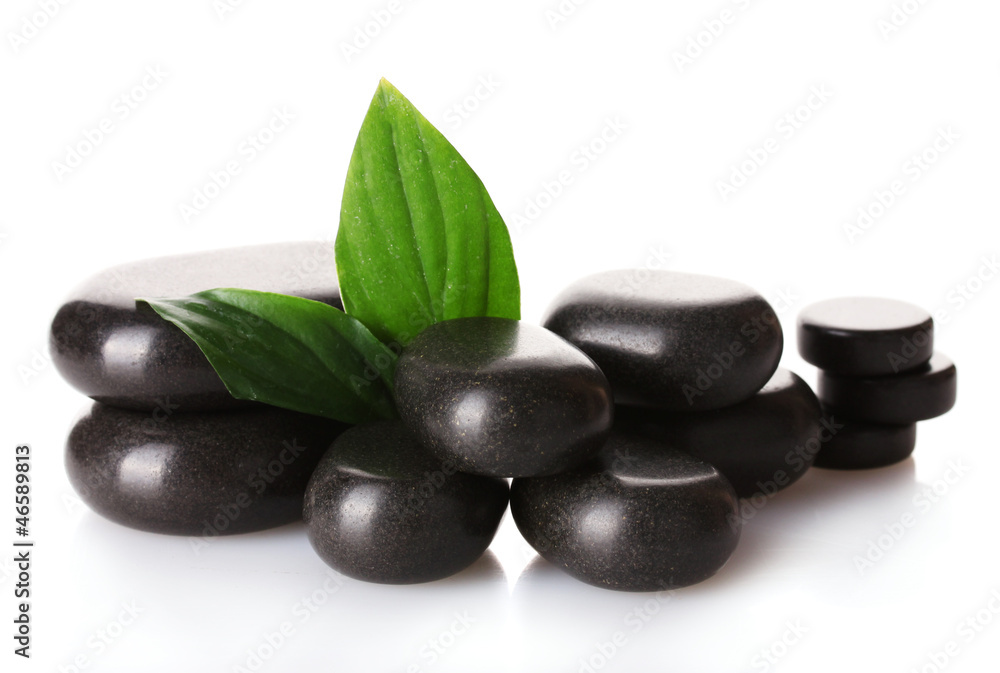 Spa stones and green leaves isolated on white Spa stones and green leaves isolated on white