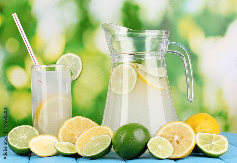 Citrus lemonade in pitcher and glass of citrus around Citrus lemonade in pitcher and glass of citrus around