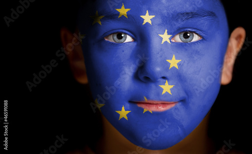 Portrait of a child with a painted EU flag