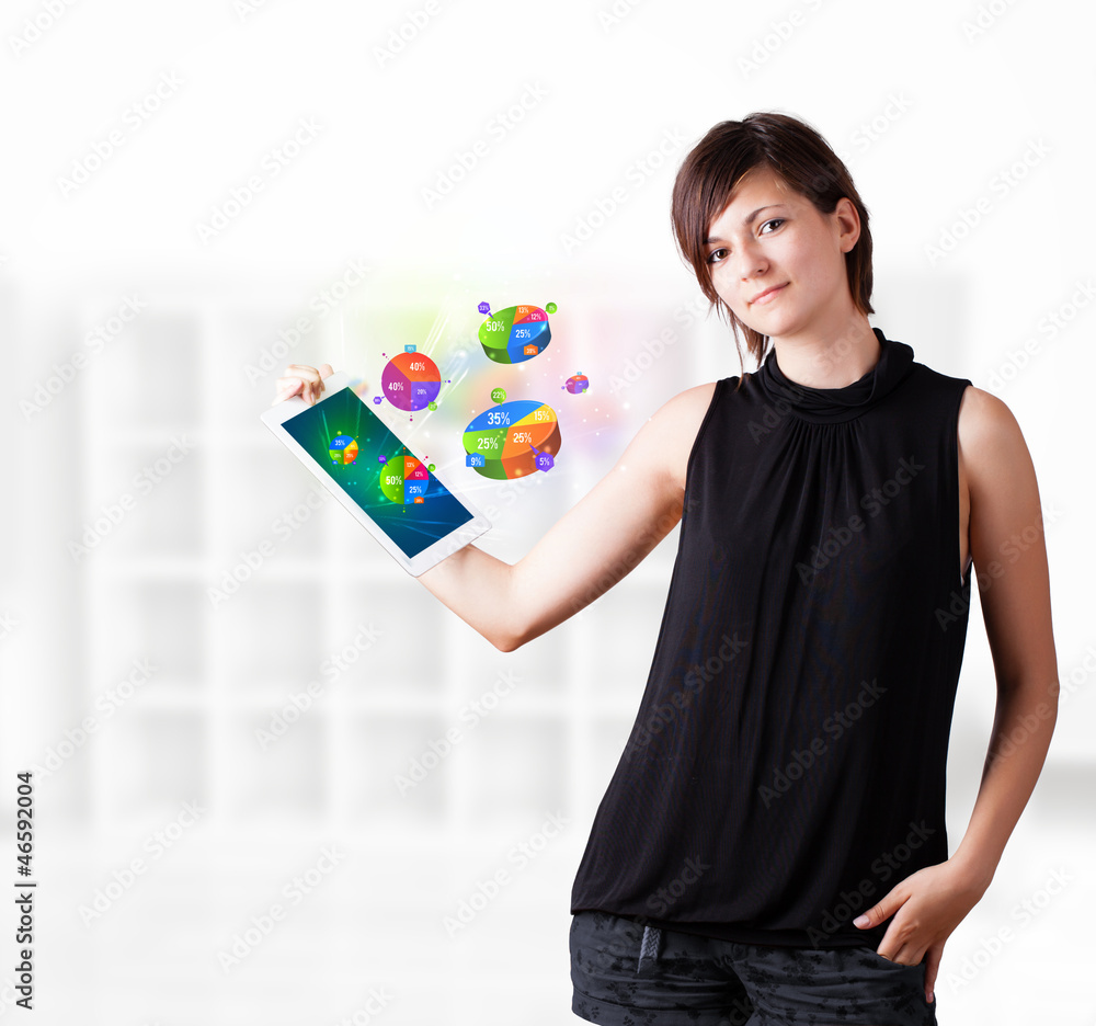 Young woman looking at modern tablet with pie charts Young woman looking at modern tablet with pie charts