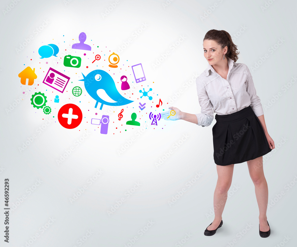 Young business woman presenting colourful social icons Young business woman presenting colourful social icons