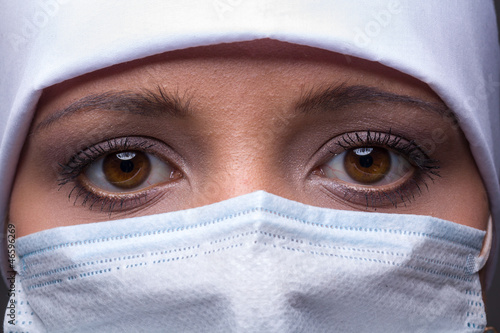 woman wearing surgical cap and mask © StepStock