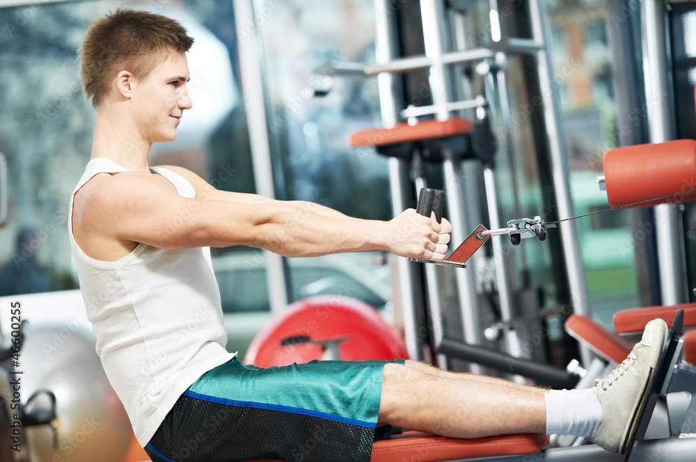 man doing back exercises at fitness gym man doing back exercises at fitness gym