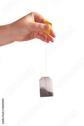 Woman hand with teabag isolated on white background