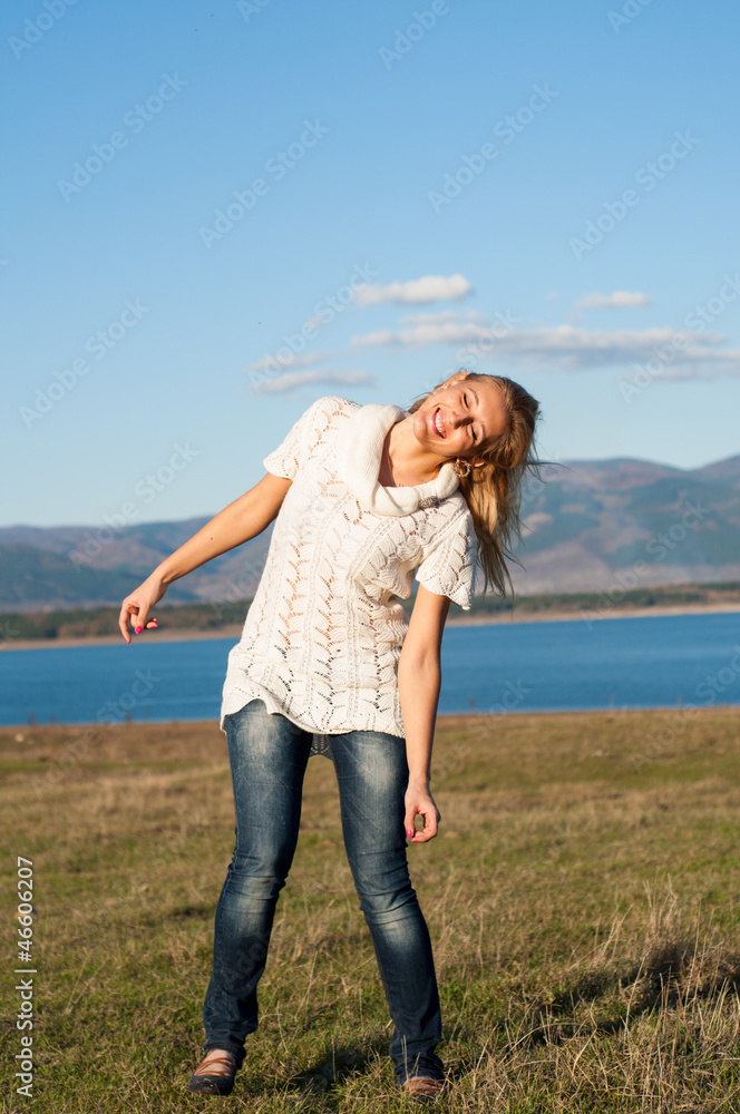 Happy girl in front of lake