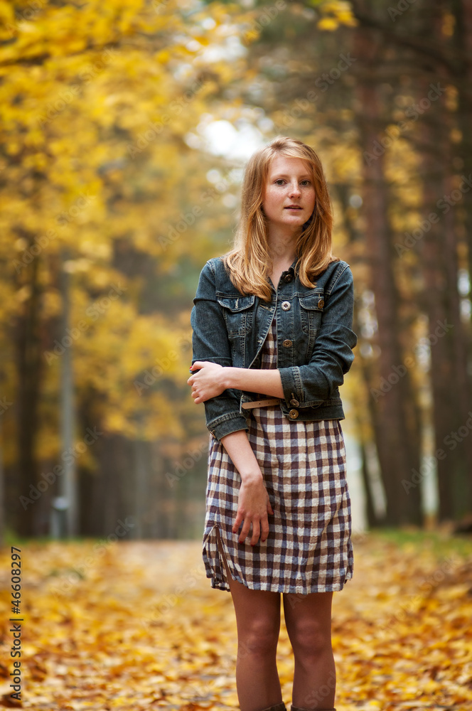 beautiful young woman on the road among the autumn trees beautiful young woman on the road among the autumn trees