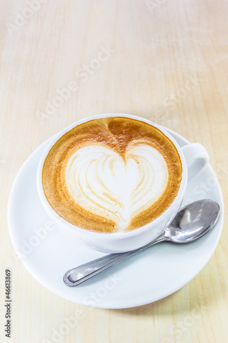 Cappuccino coffee with heart drawing in white cup