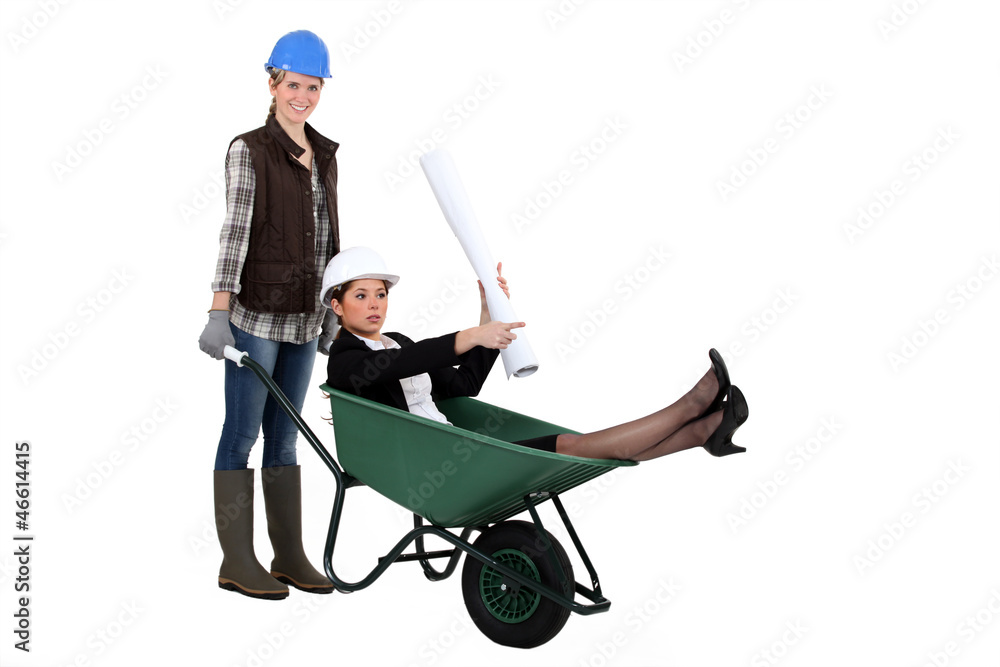 An architect getting a wheelbarrow ride. An architect getting a wheelbarrow ride.