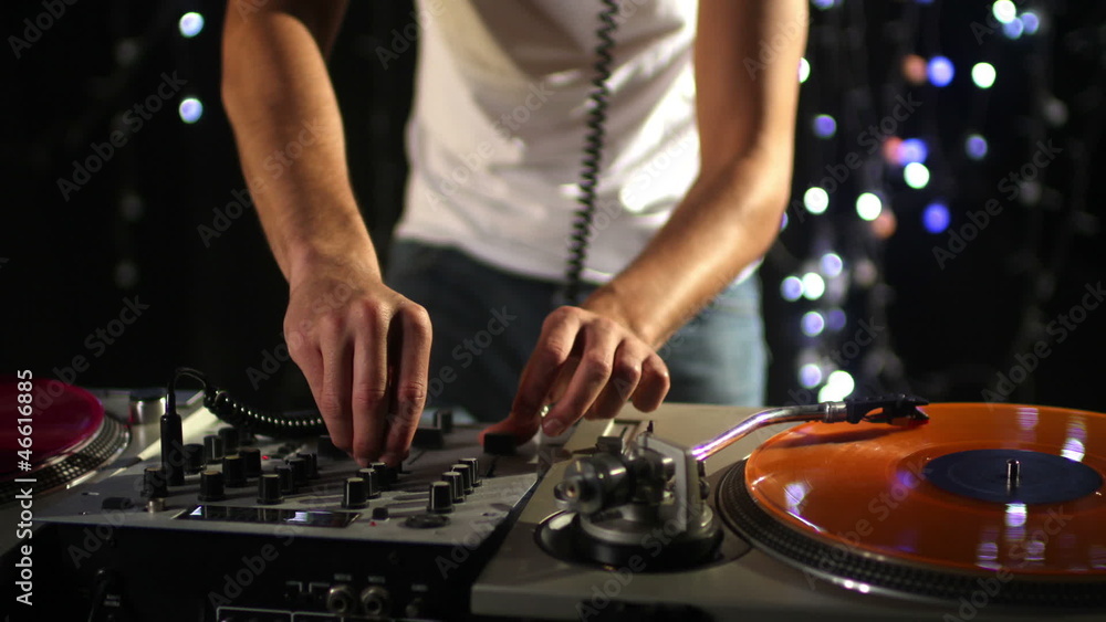 studio shoot of a cool male dj behind the turntables studio shoot of a cool male dj behind the turntables