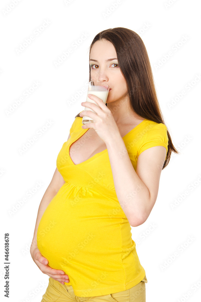 The pregnant girl drinks milk. isolated on white background The pregnant girl drinks milk. isolated on white background
