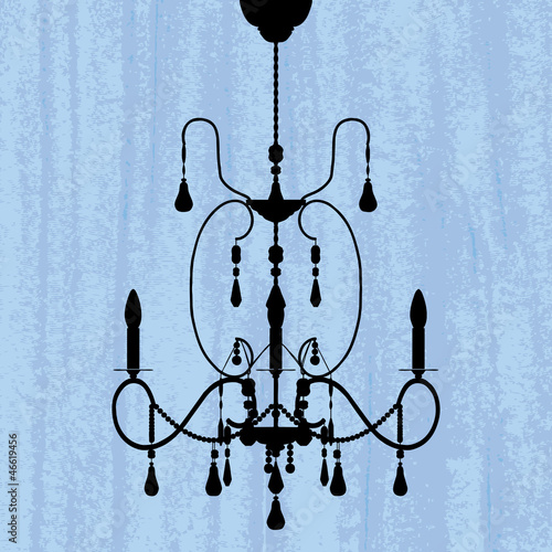 silhouette of luxury chandelier on a scratched blue wallpaper/ t