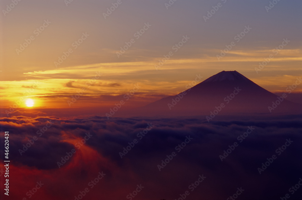 朝日に染まるうごめく雲海と富士山