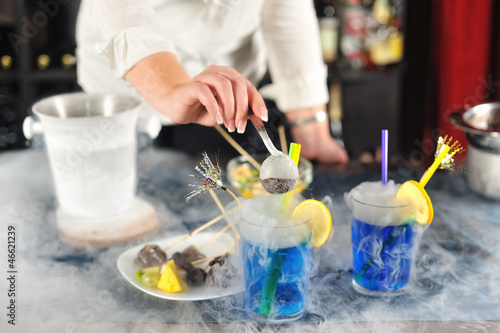 Lady bartender serving cocktails