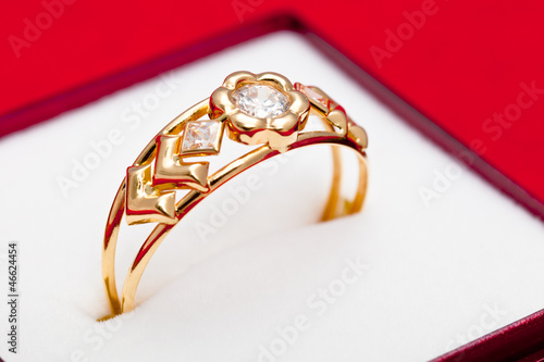 Gold ring with white zirconia enchased photo