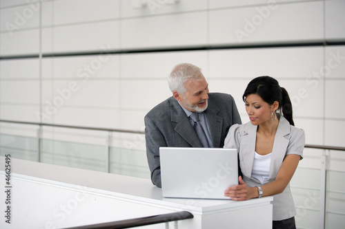 Businesspeople using a laptop