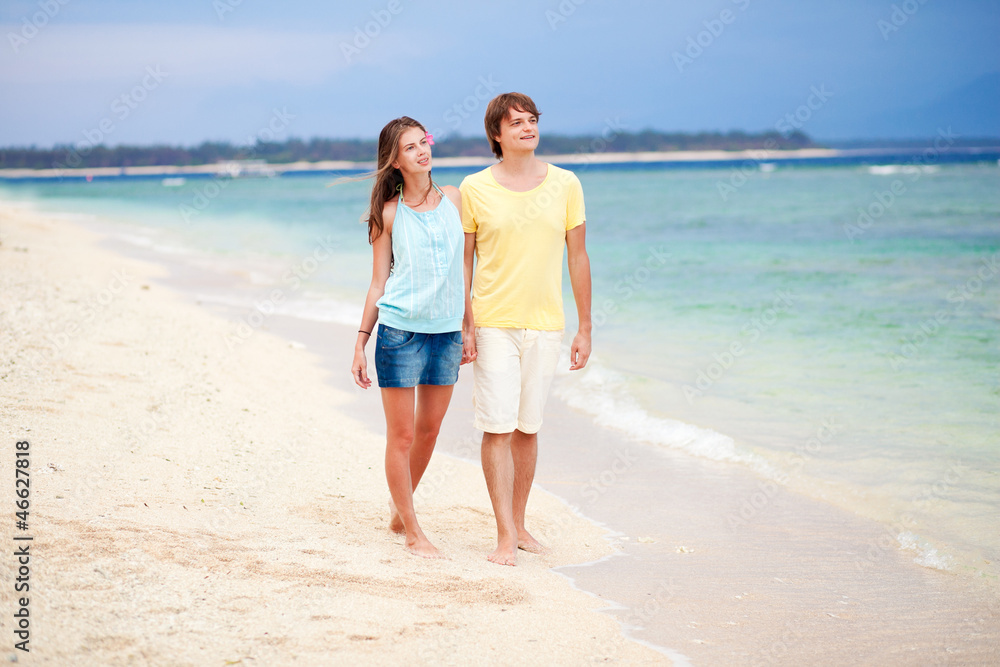 young happy couple having fun on tropical beach. honeymoon young happy couple having fun on tropical beach. honeymoon