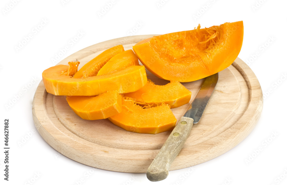 Fresh uncooked cutted pumpkin on board isolated on white Fresh uncooked cutted pumpkin on board isolated on white