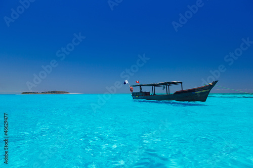 wooden boat in crisp blue water photo