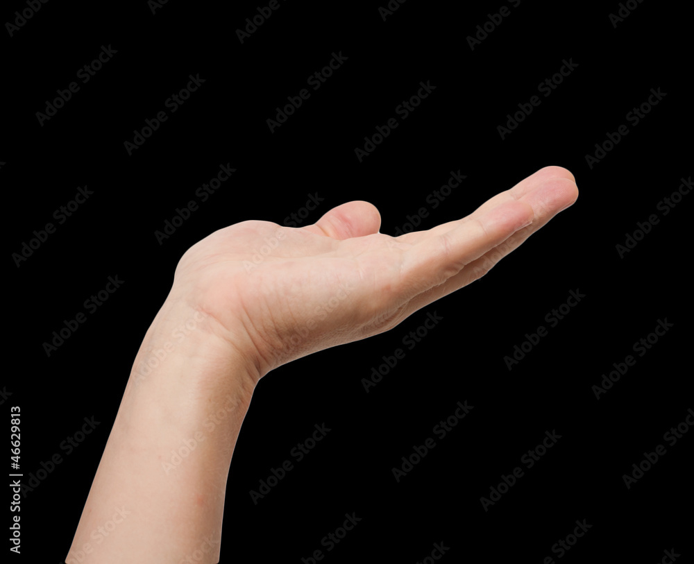 Human hand held up. Awaiting a gift. Isolated on black backgroun Human hand held up. Awaiting a gift. Isolated on black backgroun