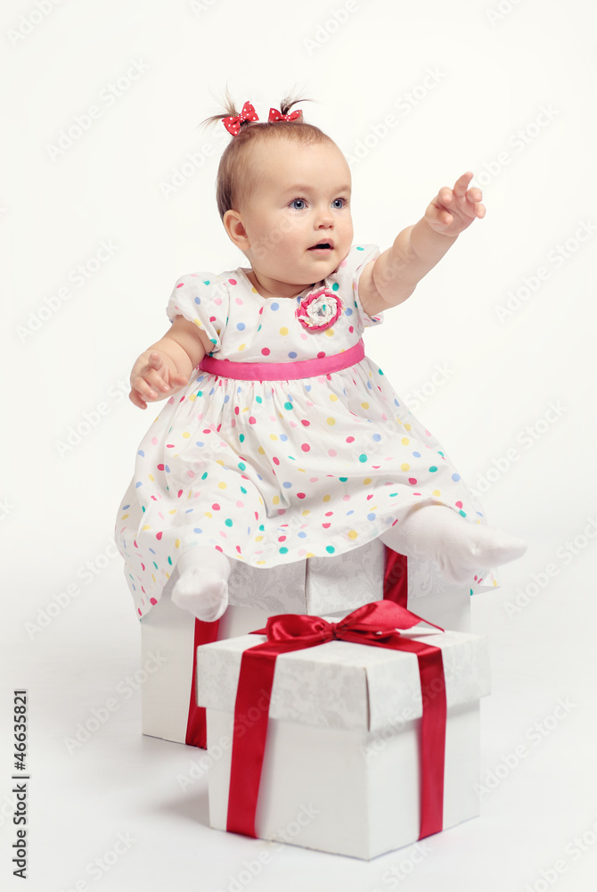 Adorable baby girl with two gift boxes Adorable baby girl with two gift boxes
