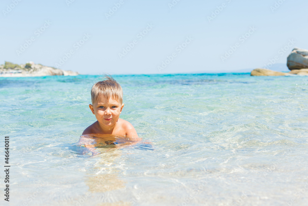 Cute boy playing in the sea Cute boy playing in the sea
