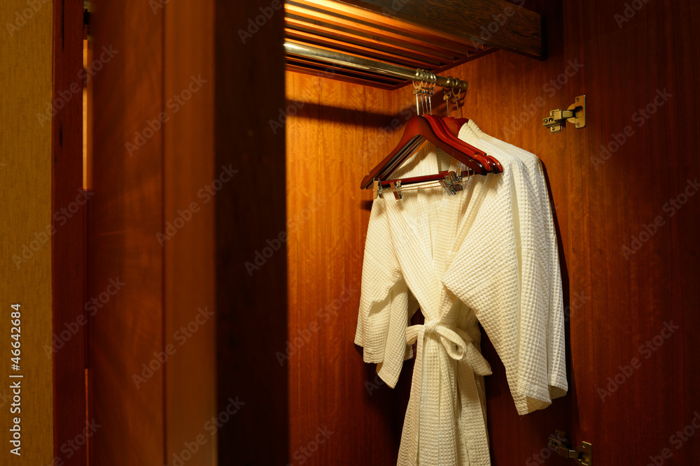 Close up of clothes hanger and twins bathrobe