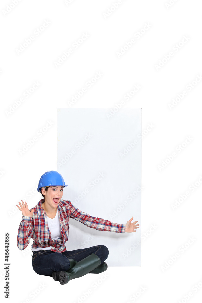Expressive female construction worker with a blank board Expressive female construction worker with a blank board