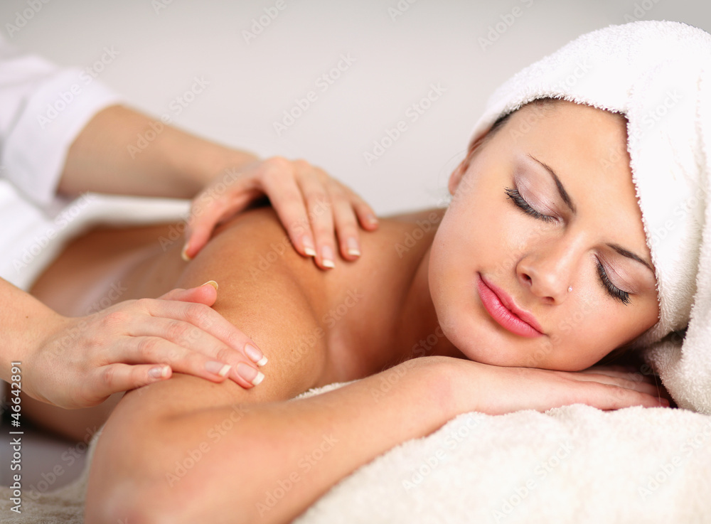 Closeup of an attractive young woman receiving massage