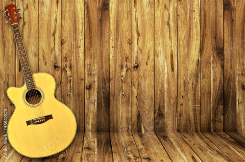 acoustic guitar on wood background