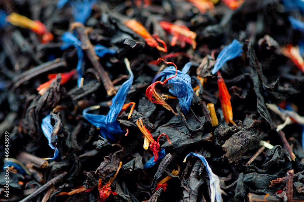 Black tea leaves and dried flowers, studio shot