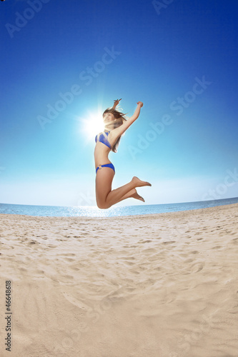 Young beautiful woman on the sand by the sea