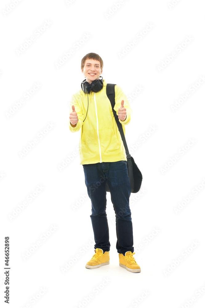 A happy teenage guy in modern clothes holding thumbs up A happy teenage guy in modern clothes holding thumbs up