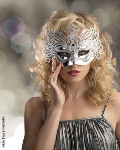 blonde girl with silver mask on the face