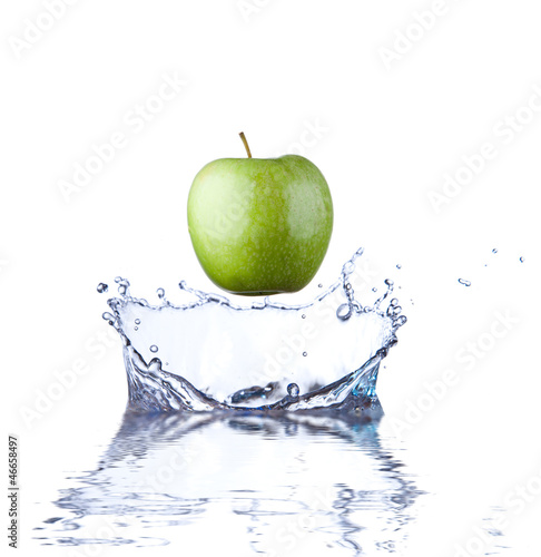 Green apple splashing into water.