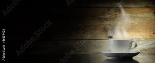 warm cup of coffee on wooden background