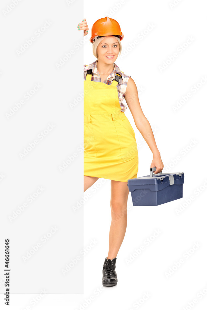 Female worker holding a tool box and posing Female worker holding a tool box and posing