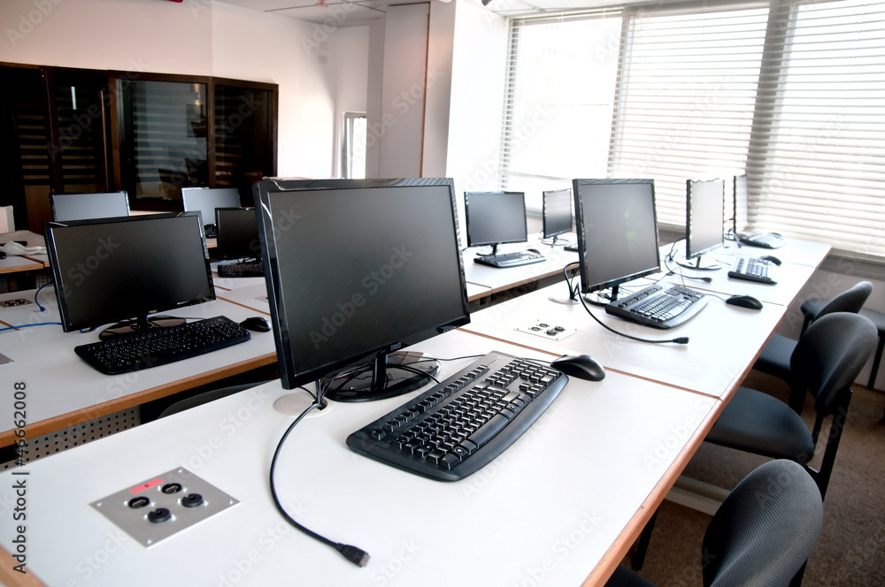Row of desktop PCs workplaces in the classroom Row of desktop PCs workplaces in the classroom