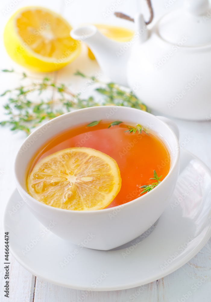 Fresh tea with lemon in the white cup Fresh tea with lemon in the white cup