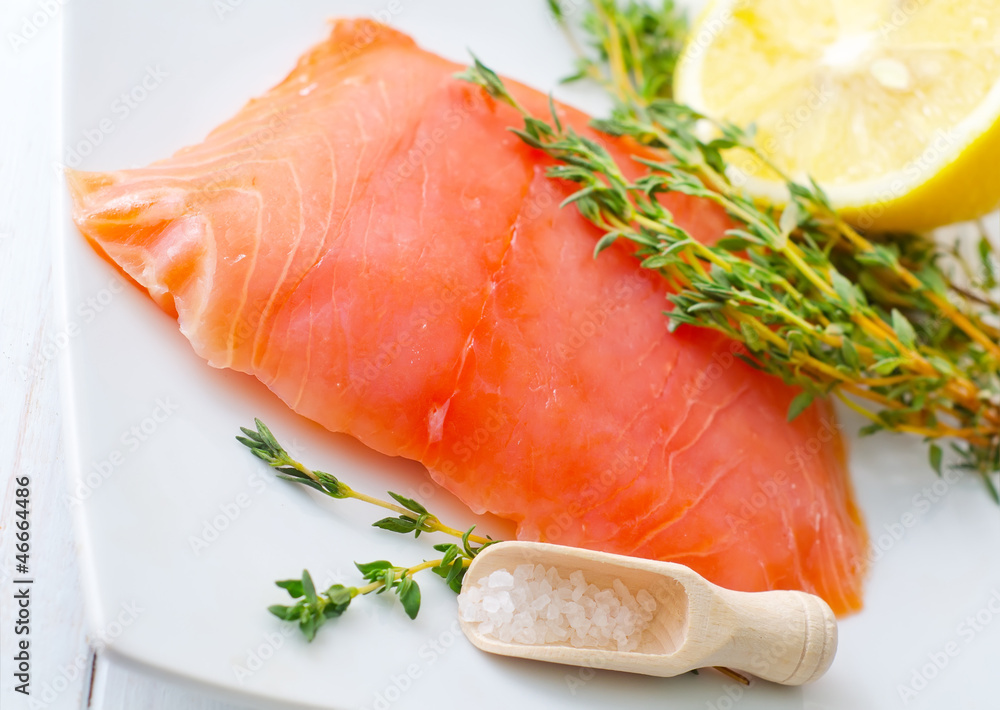Raw salmon on the white plate with thyme and salt Raw salmon on the white plate with thyme and salt