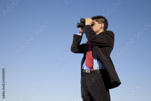 Businessman searching with his binoculars