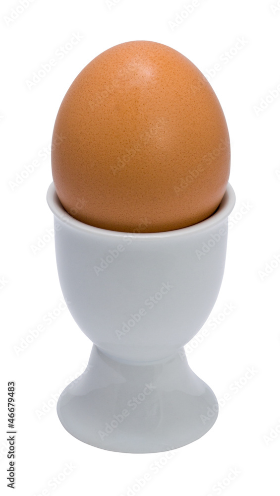 brown egg on a eggcup brown egg on a eggcup