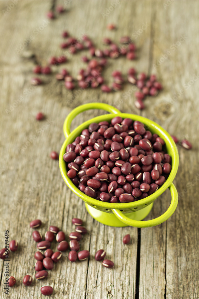 Raw red beans in a green colander Raw red beans in a green colander