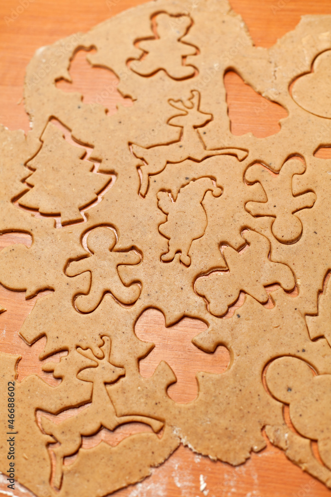 Gingerbread cookie dough with christmas themed shapes Gingerbread cookie dough with christmas themed shapes