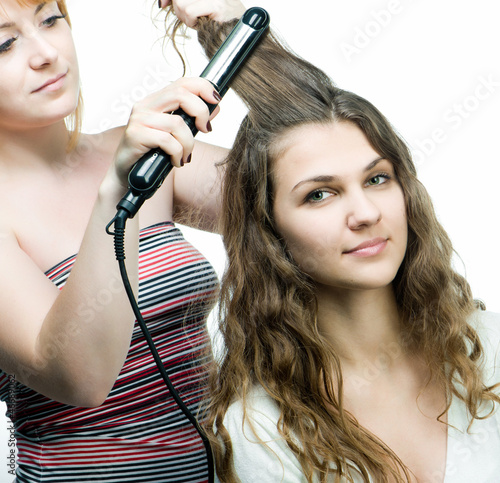 Hairdresser makes hairstyle