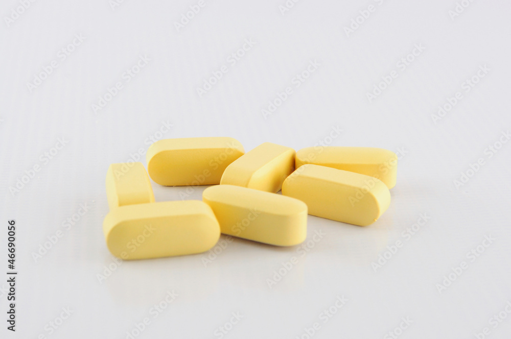 Yellow tablet on white backgroud Yellow tablet on white backgroud