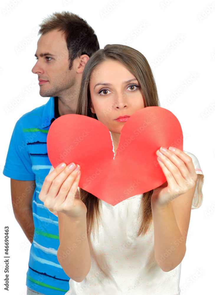 Attractive young girl holding broken paper red valentine heart Attractive young girl holding broken paper red valentine heart